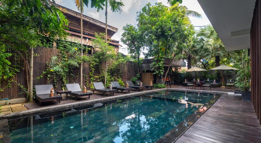 a swimming pool with a pool table and chairs, King Rock Boutique Hotel in Siem Reap
