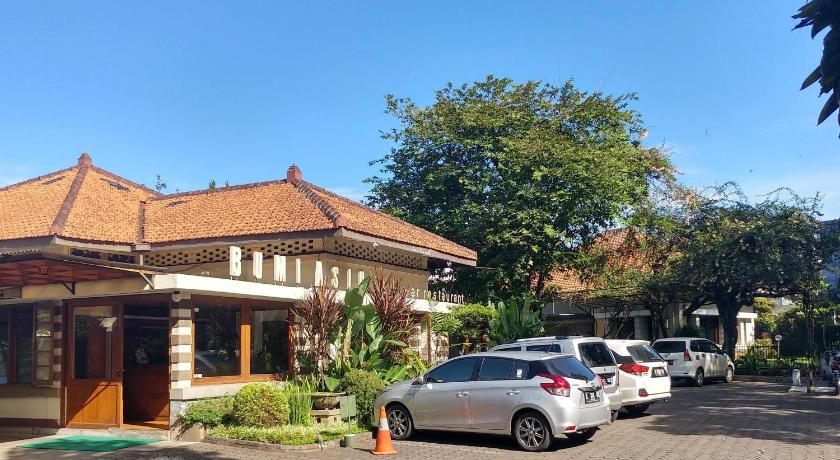 a car parked on the side of a street, Hotel Bumi Asih in Bandung