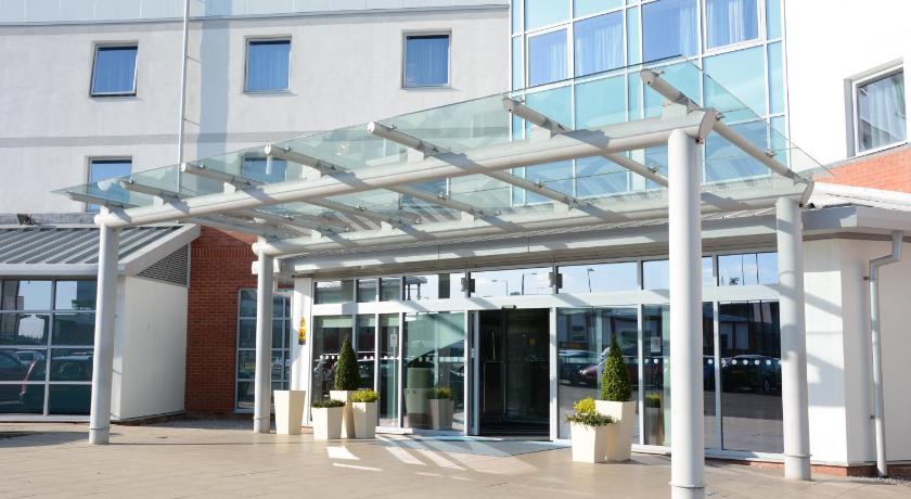 a large white building with a large window, Holiday Inn Express Leigh - Sports Village in Leigh