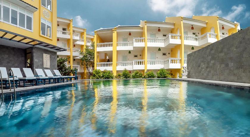 a large swimming pool with a balcony overlooking a city, Hoi An Aurora Riverside Hotel & Spa in Hoi An