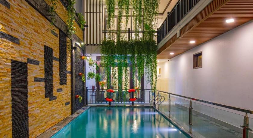 a large swimming pool in a large building, Serenity Villa Hoi An in Hoi An