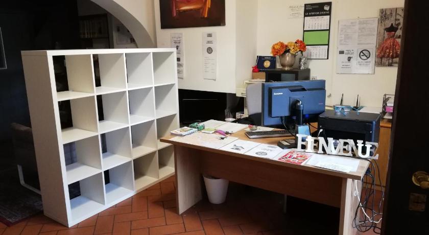a room with a table, bookshelf, and a painting on the, La casa di Filippo in Pisa