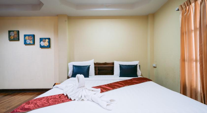 a hotel room with a bed and a dresser, Jintana Resort in Buriram