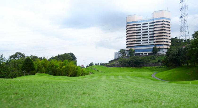 a grassy field with tall buildings and trees, Myogi Green Hotel in Takasaki