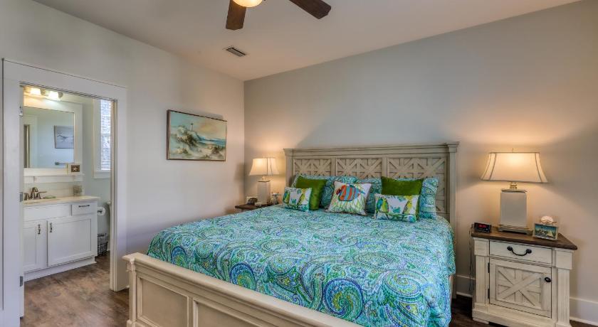 a bedroom with a bed and a dresser, Barefoot Cottages #C56 in Port Saint Joe