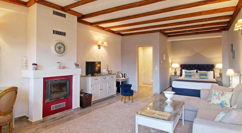 a living room filled with furniture and a fireplace, AlmondHouse Suites with Fireplace - ADULTS ONLY in Arachova