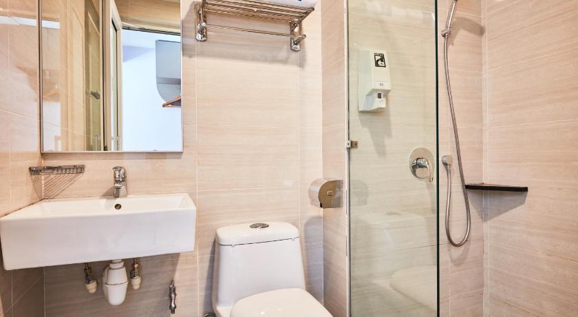 a bathroom with a toilet, sink, and shower, ibis budget Singapore Joo Chiat (SG Clean, Staycation Approved) in Singapore
