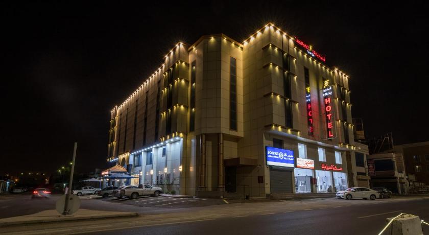 a large building with a clock on the side of it, Flora Park 2 Hotel Suites in Yanbu