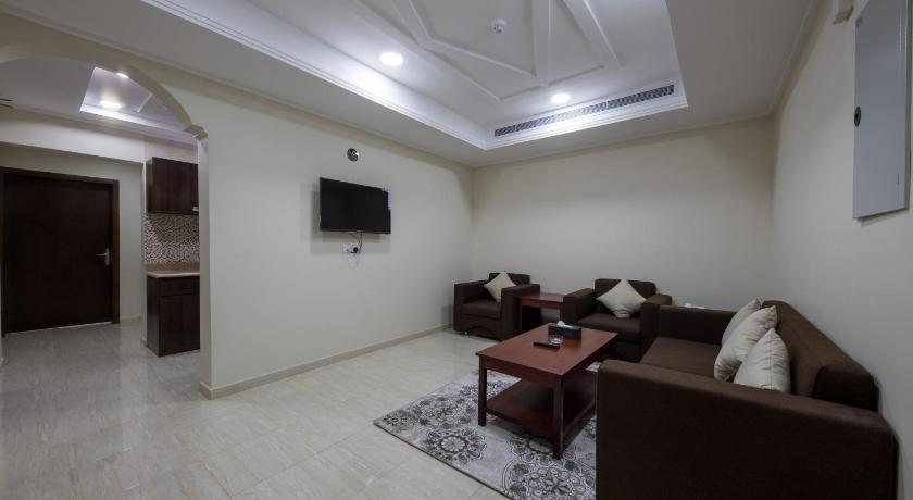 a living room filled with furniture and a dog, Flora Park 2 Hotel Suites in Yanbu