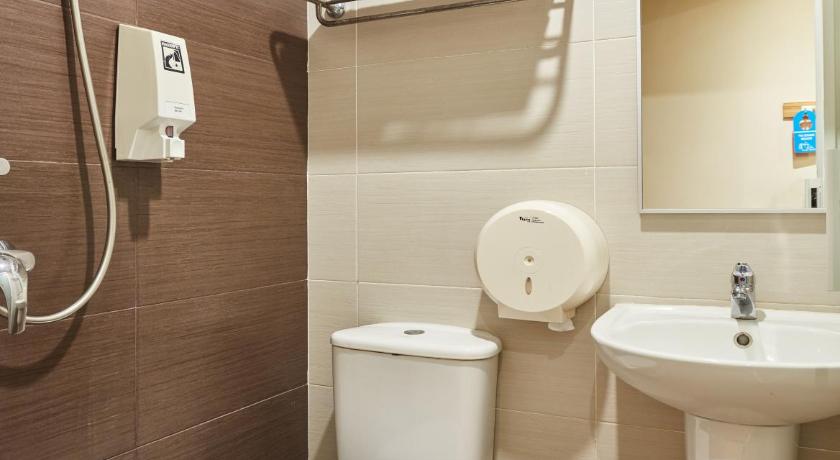a white toilet sitting next to a sink in a bathroom, ibis budget Singapore West Coast (SG Clean Certified) in Singapore