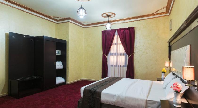 a hotel room with a large bed and a large window, Flora Park Yanbu 1 Hotel Suites in Yanbu