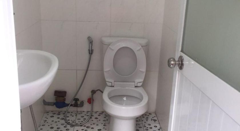 a white toilet sitting in a bathroom next to a sink, Guesthouse Minh Thu in Ho Chi Minh City