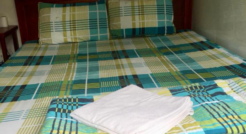 a bed that has a blue blanket on it, Guesthouse Minh Thu in Ho Chi Minh City