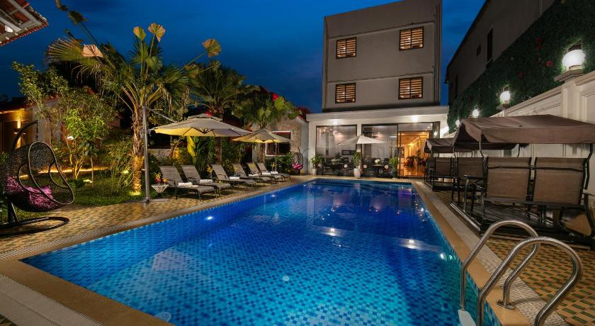 a swimming pool with a large pool table and chairs, Tam Coc Holiday Hotel & Villa in Ninh Bình
