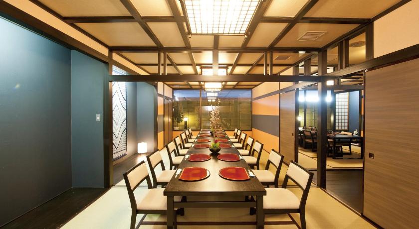 a dining room with tables and chairs and a large window, Ishinomaki Grand Hotel in Ishinomaki