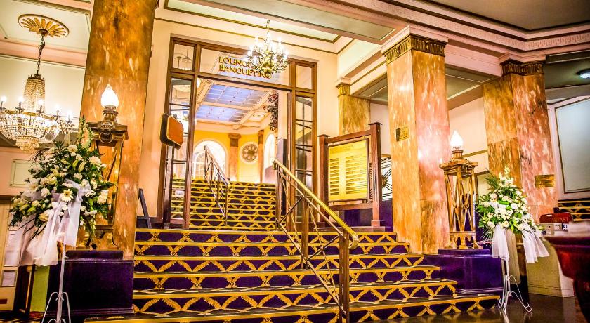 a large room with a large staircase leading to a stairwell, Britannia Adelphi Hotel in Liverpool