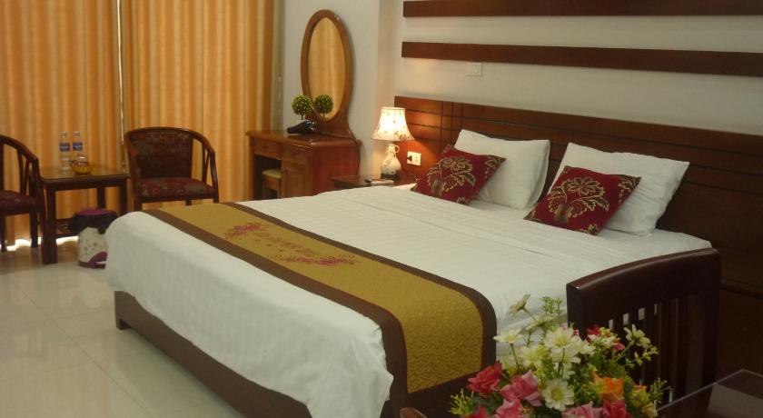 a hotel room with two beds and a table, Asia Apartment Hotel Bac Ninh in Bac Ninh