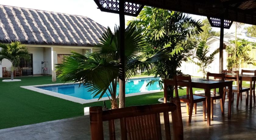 a patio area with a pool table and chairs, HIGALA B&B in Bohol