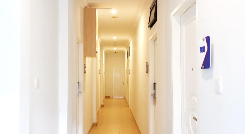 a hallway with a white wall and a black and white checkered floor, Cordex Oase Pekanbaru in Pekanbaru
