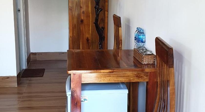 a wooden table in a room with a wooden floor, Phu Vy Bungalow Phu Quoc in Phú Quốc Island