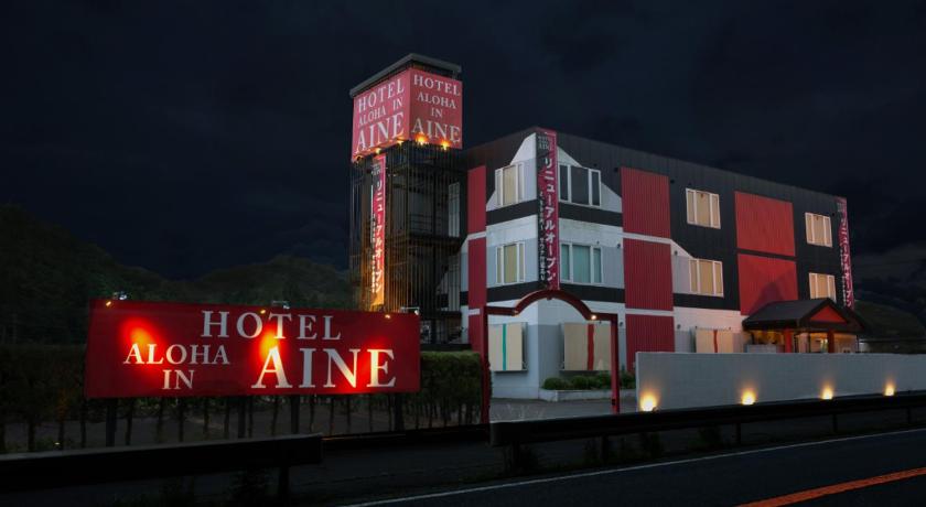 a red and white train on a train track, Aloha Inn Aine (Adult Only) in Fukuchiyama