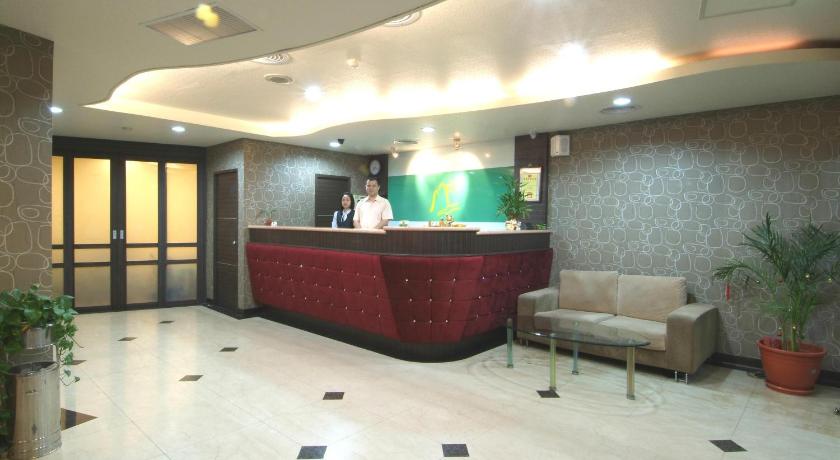 a living room filled with furniture and a large screen tv, Left Bank Hotel in Hsinchu