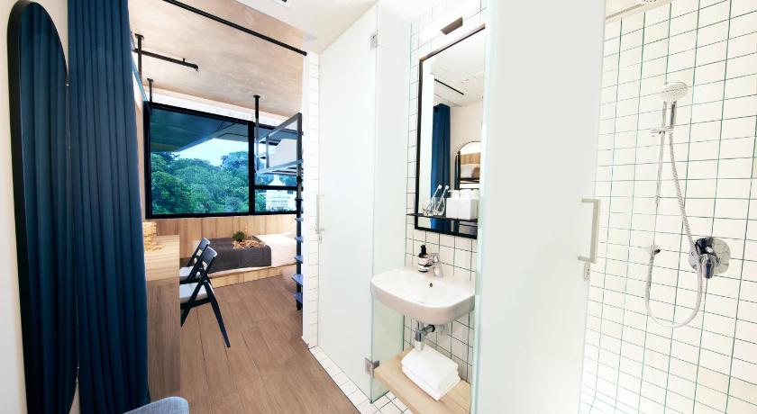 a bathroom with a toilet a sink and a shower, lyf Funan Singapore (SG Clean Certified) in Singapore