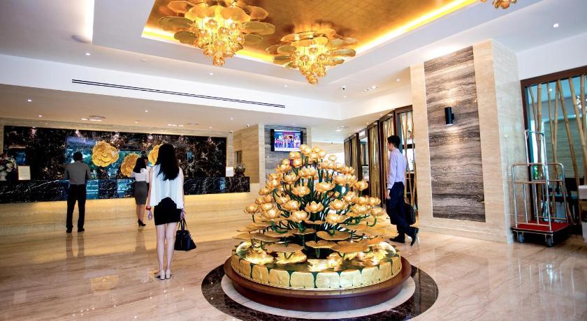 people standing around a christmas tree, Vouk Hotel Suites in Penang