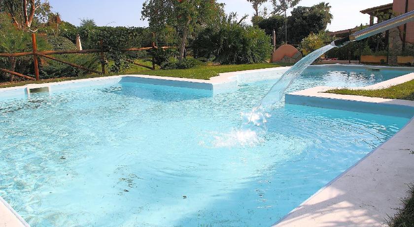 a pool with a pool table and a swimming pool, Villaggio Piscina Rei in Costa Rei