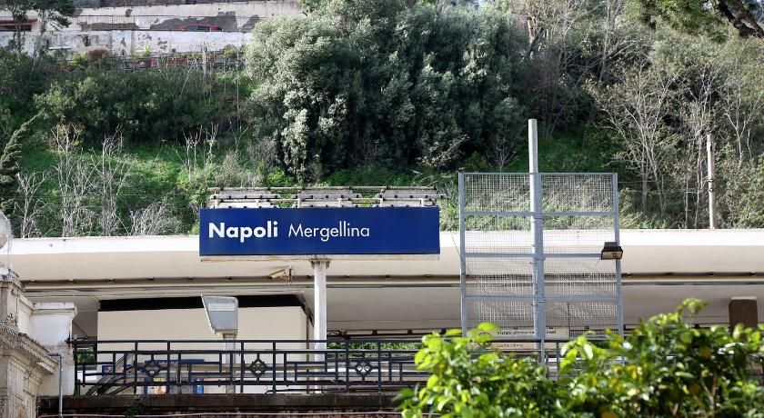 a blue and white train is on the tracks, MaMa Home in Naples