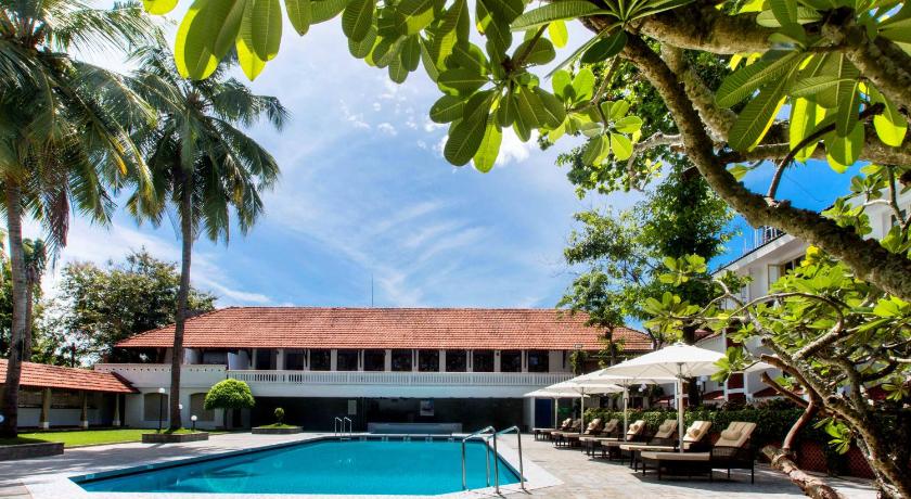 a large white house with a pool and trees, Casino Hotel in Kochi
