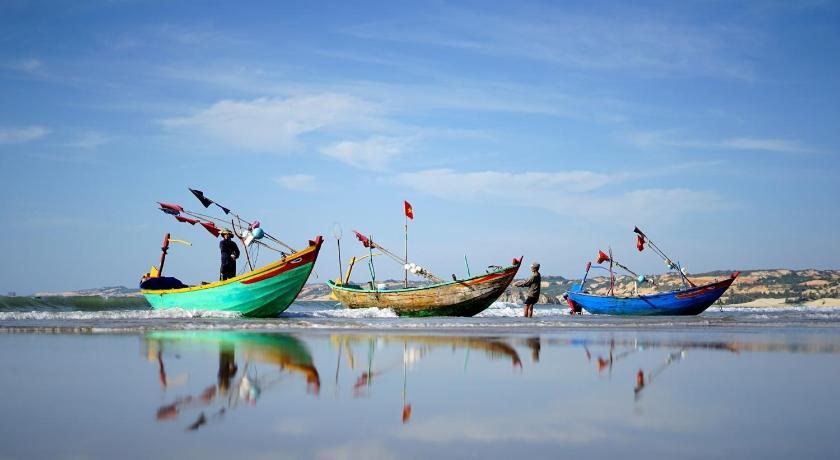 a number of small boats on a beach, Stop And Go Lang Chai Boutique Resort in Phan Thiet