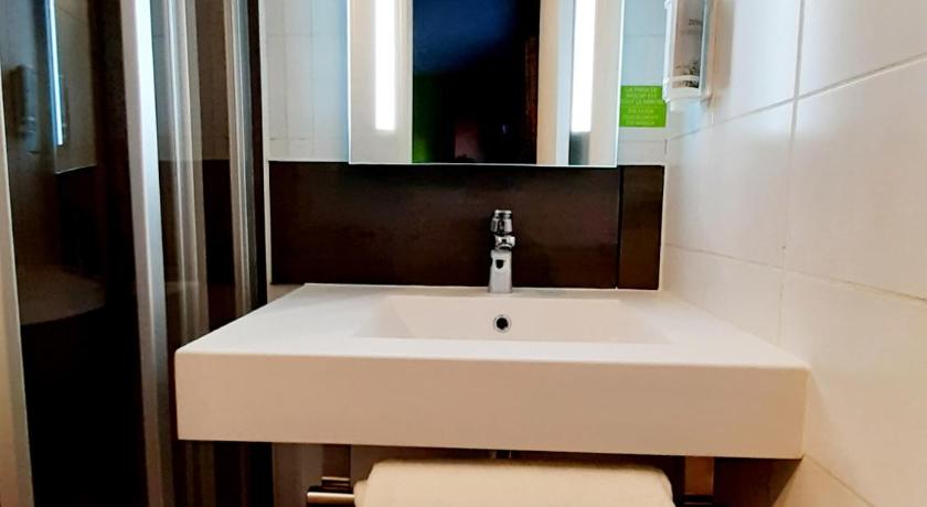 a bathroom with a sink, toilet and shower stall, Brit Hotel Confort Rouen Centre in Rouen