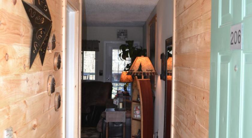 a living room with a door open to a hallway, River Place Condos 206 2BD in Pigeon Forge (TN)