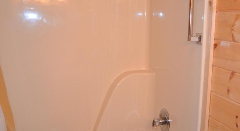 a white bath tub sitting next to a white toilet, River Place Condos 206 2BD in Pigeon Forge (TN)
