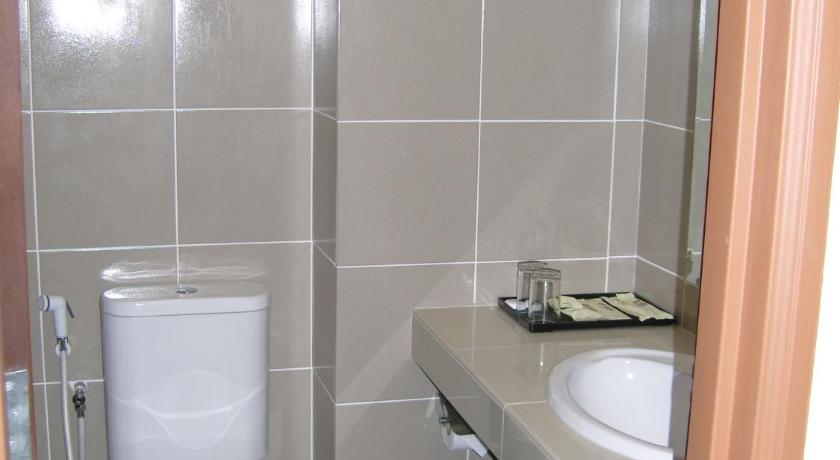 a bathroom with a toilet, sink, and shower, Hotel Orient in Johor Bahru
