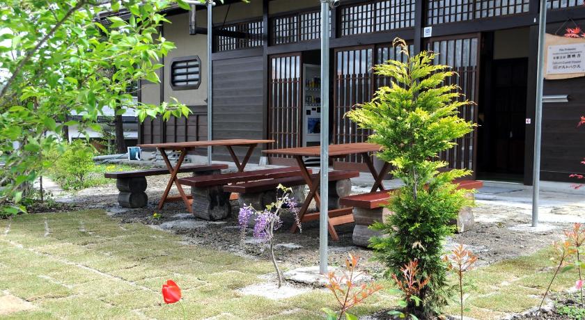 a wooden bench sitting in front of a building, Sakura Guest House in Takayama