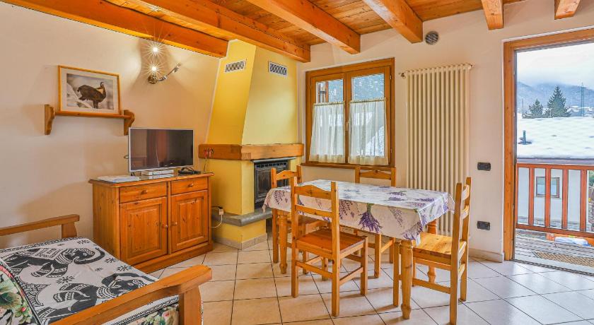 a living room with a dining room table and chairs, Apartments La Gran Becca in Antei Sant'Andrea