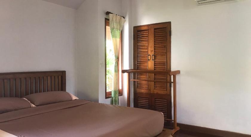a bedroom with a bed and a dresser, Pai Loess Resort in Pai