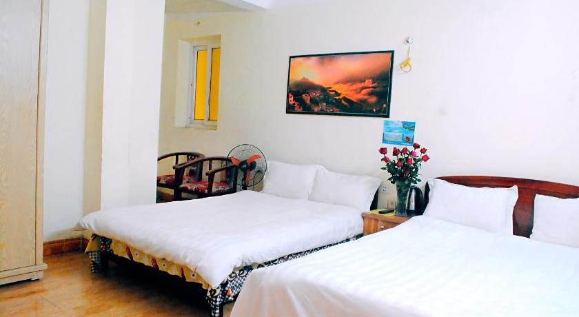 a hotel room with a bed and a desk, Minh Anh Guesthouse in Sapa