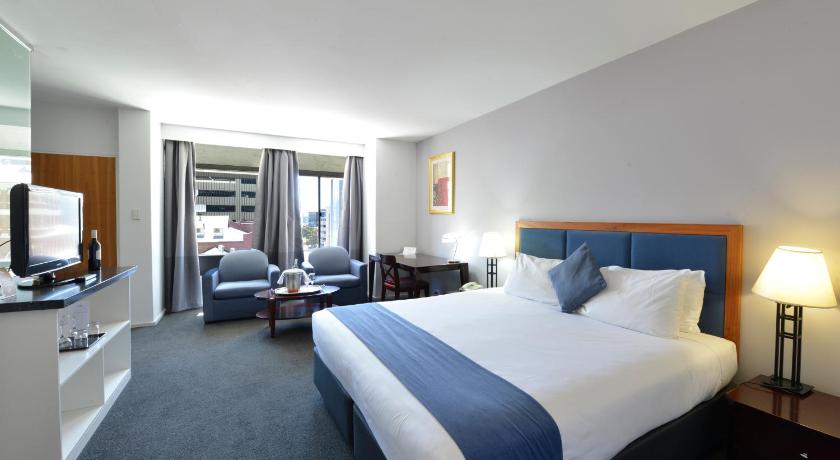 a hotel room with two beds and a television, Seasons of Perth in Perth