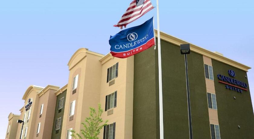 an american flag on a pole in front of a building, Candlewood Suites Denver Northeast - Brighton in Brighton (CO)