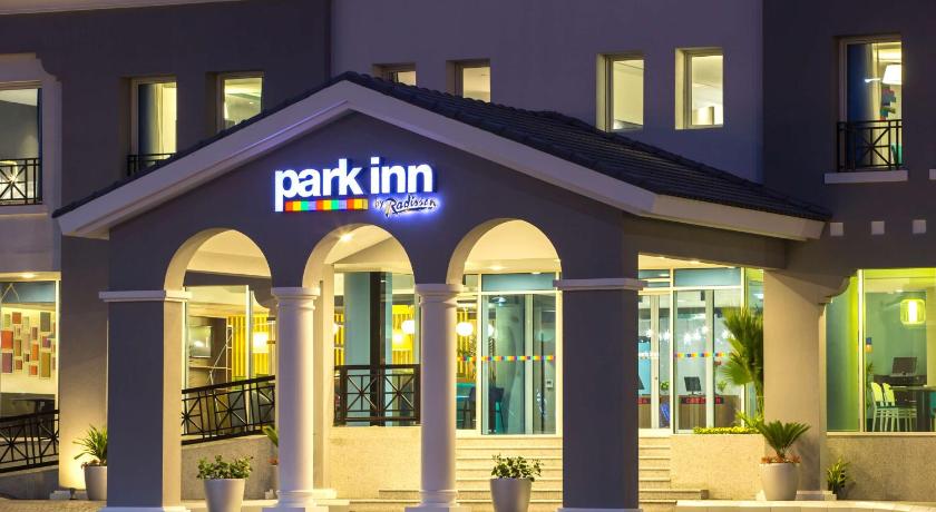 a large building with a sign on the front of it, Park Inn by Radisson Dammam in Dammam