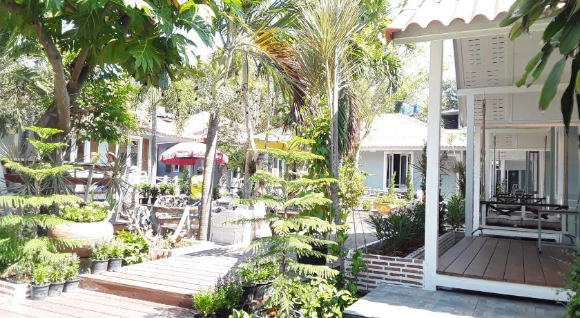 a patio area with a patio table, chairs, and umbrellas, Barbados Terrace in Ko Samet