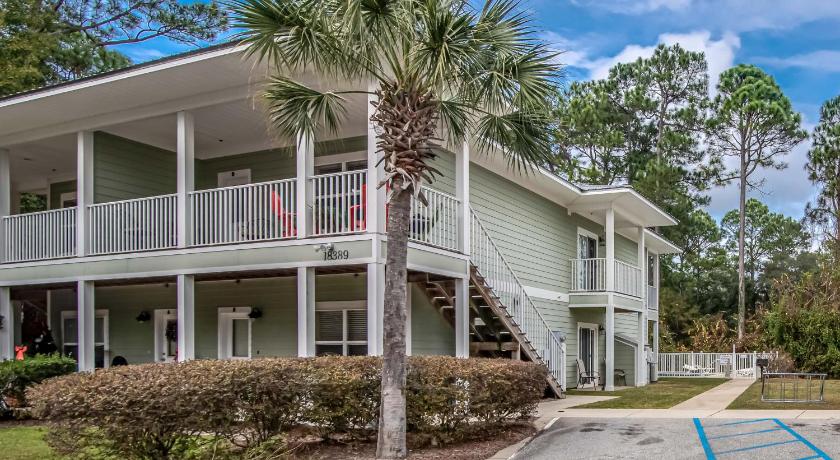 a large white house with a tree on top of it, Laguna Breeze Unit C Condo in Gulf Shores (AL)