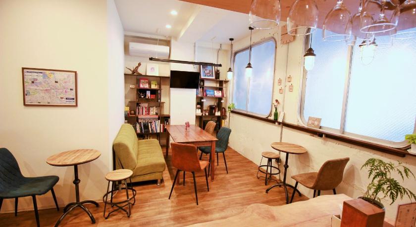 a living room filled with furniture and a table, Hostel TOKI in Fukuoka