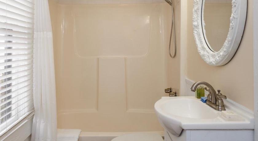 a bathroom with a toilet, sink, and bathtub, The Heirloom Inn in Mount Dora (FL)