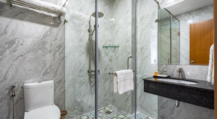 a bathroom with a shower, toilet and sink, Emerald Central  in Ho Chi Minh City