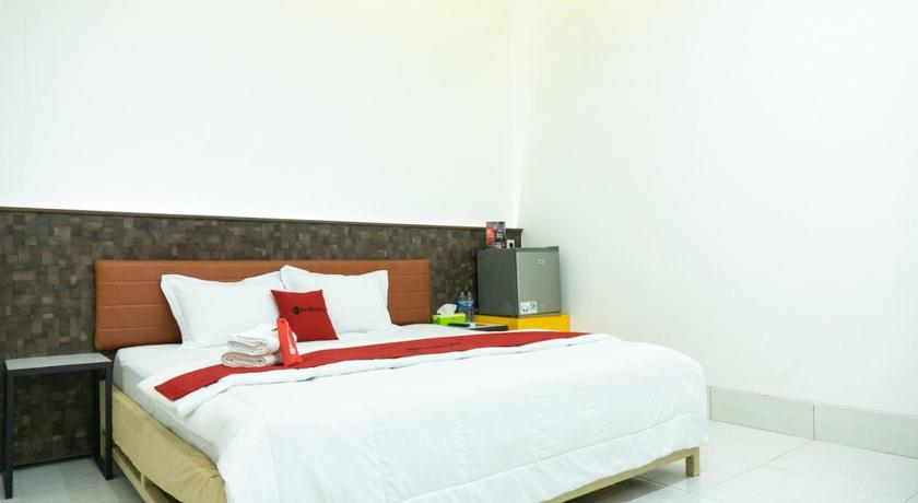 a bed with a white comforter and pillows, RedDoorz Plus @ Ende City Center in Ende