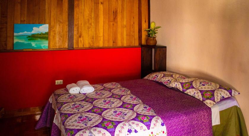 a bedroom with a bed and a desk, Mayan Spirit in Flores